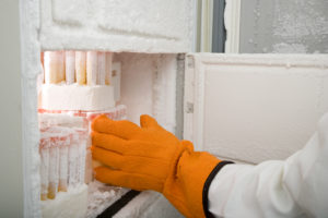Scientist retrieving a vile from the cryogenic freezer.